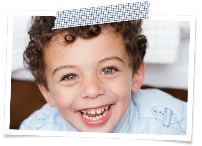 young smiling boy with curly dark hair