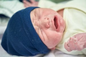 newborn baby with blue hat